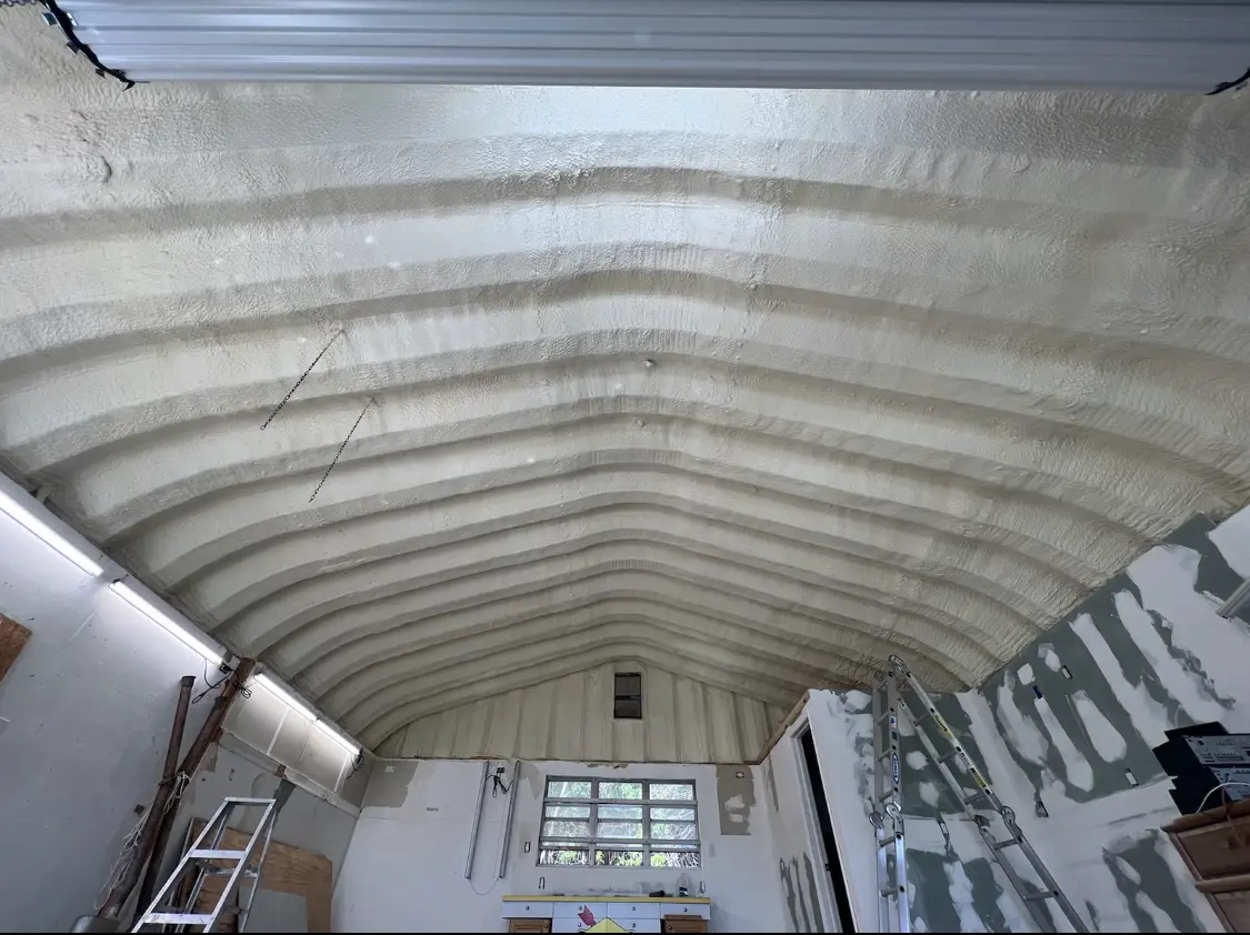 Spray polyurethane foam applied to the underside of a metal roof deck in Taylor